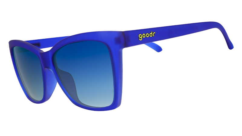 Three-quarter angle view of blue angled cat-eye sunglasses with blue gradient lenses.