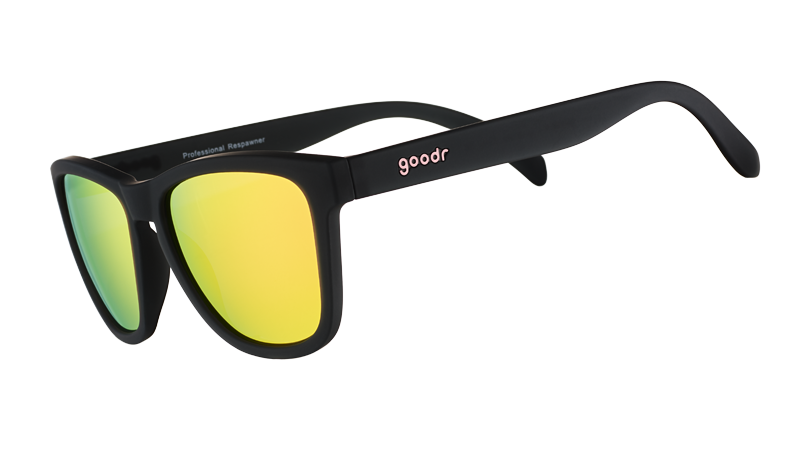 Three-quarter angle view of black sunglasses with square-shaped hot pink reflective lenses.