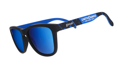 Three-quarter angle view of MLS San Jose Earthquakes shades tilted down. Black+blue frames. Blue reflective lenses.