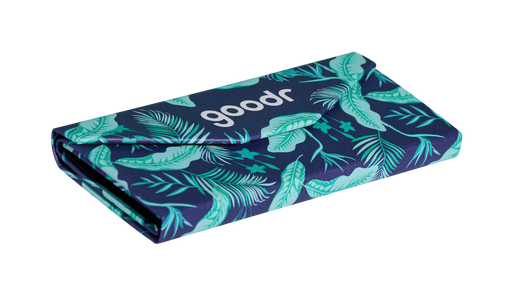 Three-quarter angle view of the Enter the Fold navy and teal tropical-print sunglasses case, showcasing its collapsible design.