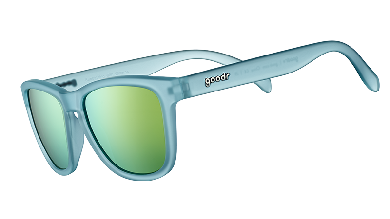 Three-quarter angle view of square-shaped sunglasses with light blue translucent frames and gold reflective lenses.