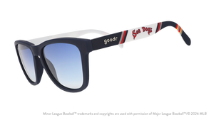 Three-quarter angle view of sunglasses. Dark blue frames w/ Sea Dogs on temples + blue gradient lenses.