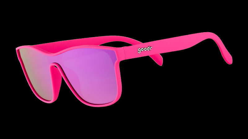 Three-quarter angle view of futuristic hot pink sunglasses with a flat purple single lens.