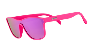 Three-quarter angle view of futuristic hot pink sunglasses with a flat purple single lens.