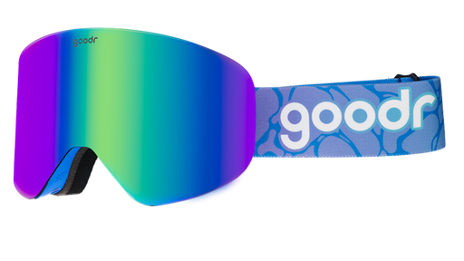 Three-quarter view of cobalt-blue snow goggles with green reflective lens. Strap features a blue and purple abstract design.