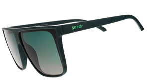 Three-quarter angle view of deep green oversized flat-top sunglasses with green gradient lenses.
