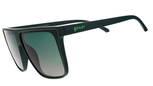 Three-quarter angle view of deep green oversized flat-top sunglasses with green gradient lenses.