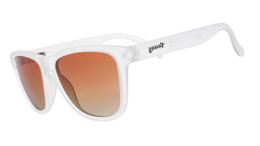 Three-quarter view of a pair of clear sunglasses with brown gradient lenses in a classic frame shape.