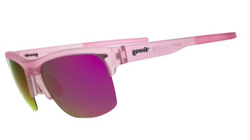 Three-quarter angle view of half-rim translucent pink sunglasses with pink reflective polarized lenses and light pink silicone grips on the inner arms.