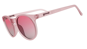 A pair of pink goodr sunglasses with round frames and pink lenses