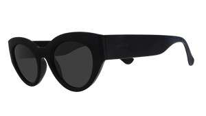 Three-quarter angle view of translucent black, retro-inspired angled cat-eye sunglasses with non-reflective lenses.