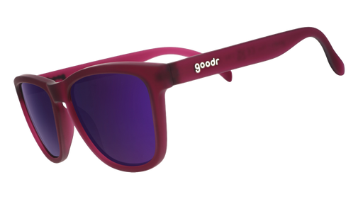 Three-quarter angle view of translucent purple sunglasses with reflective purple lenses.