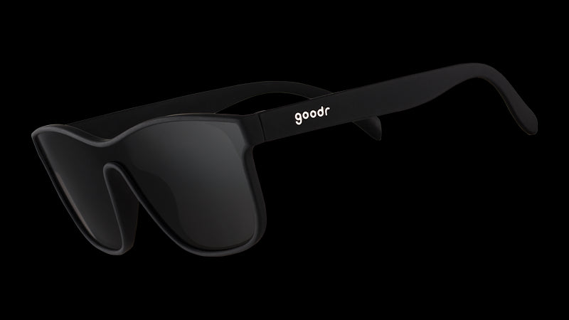 Three-quarter angle view of futuristic-looking black sunglasses with a non-reflective black flat single lens.