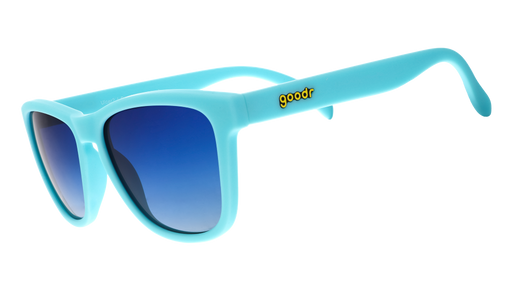 Three-quarter angle view of teal sunglasses with blue-green gradient polarized lenses inspired by antacid relief meds.