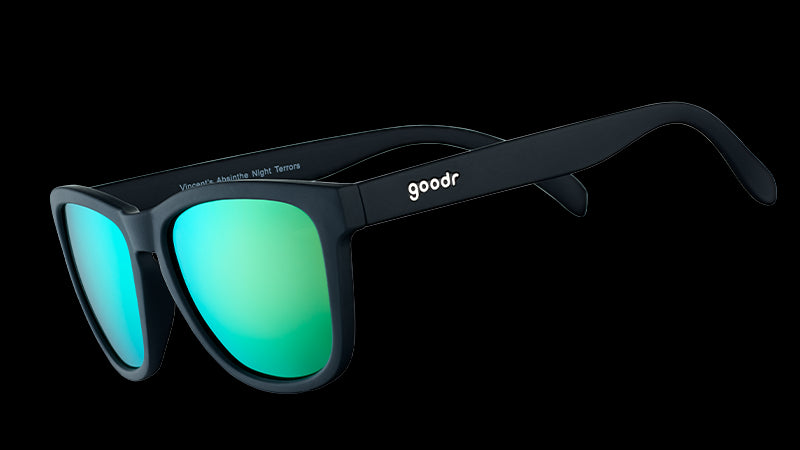 Three-quarter angle view of square-shaped black sunglasses with mirrored green lenses.