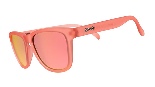 Three-quarter angle view of limited-edition ginger-colored sunglasses with light pink reflective polarized lenses.