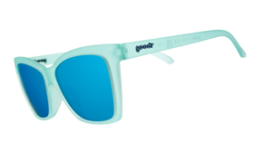 Three-quarter angle view of translucent teal angular sunglasses with reflective teal lenses.