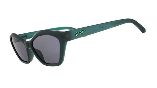Three-quarter-angle view of translucent, dark green angular Deco G sunglasses with black non-reflective lenses. 