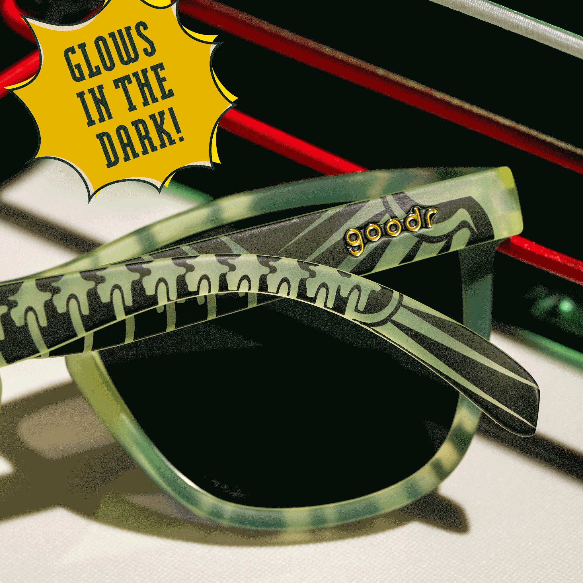 Close-up shot taken from behind of a pair of glow-in-the-dark black and green sunnies with a skeletal design.