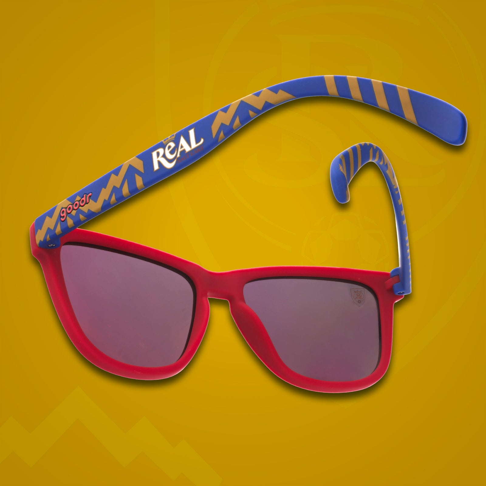 Three-quarter angle back view of MLS Real Salt Lake frames. Red+blue patterned frames. Amber reflective lenses.