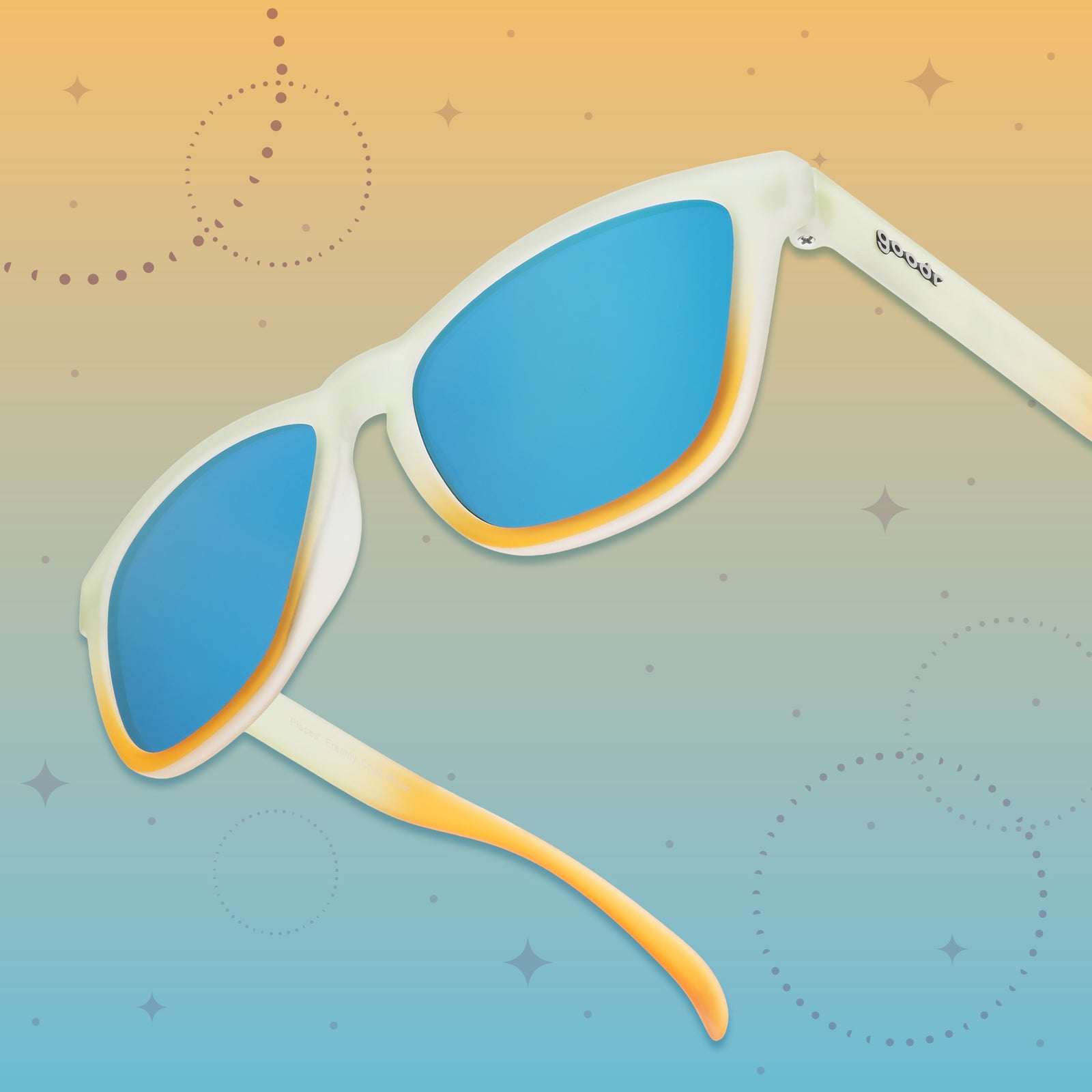 Light teal-to-yellow sunglasses with the goodr logo featuring light blue reflective lenses on a yellow-to-blue starry background.