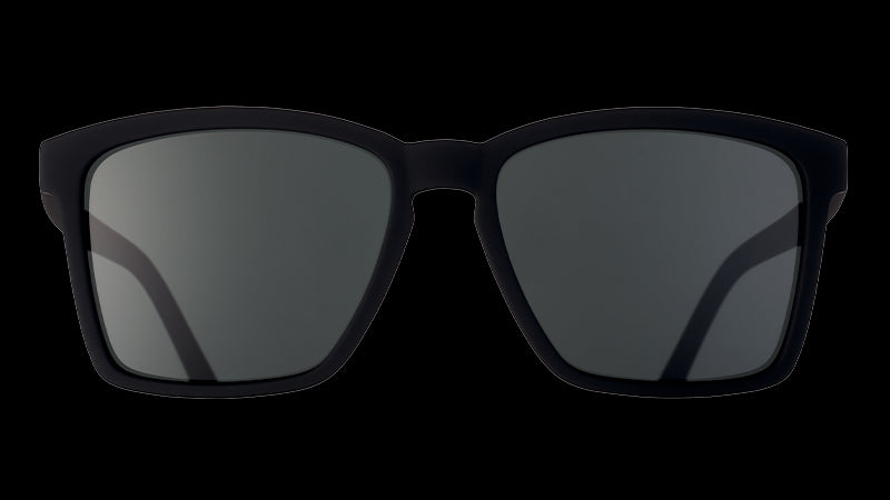 Front view of square-shaped slim-fit black sunglasses with non-reflective black lenses.