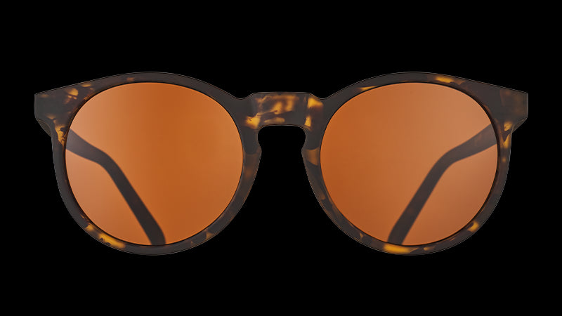 Front view of round brown tortoiseshell sunglasses with circle-shaped brown non-reflective lenses.