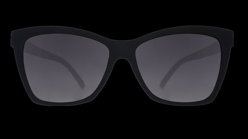 Front view of stylish black sunglasses with an angled cat-eye shape and non-reflective black gradient lenses.