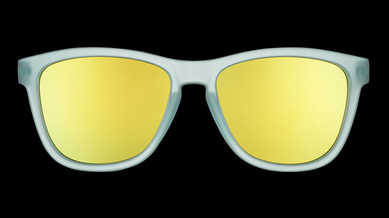 Front view of sunglasses with light blue translucent frames and reflective gold lenses.