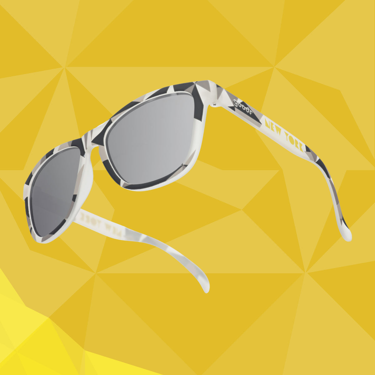 Back view of gray sunglasses with a tonal geometric pattern against a yellow geometric-patterned background.