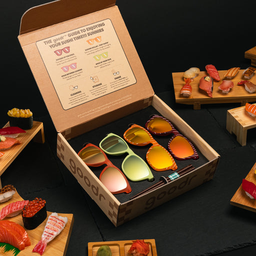 Three-quarter angle view of open-lid bento box packaging for a limited-edition sushi-inspired sunglasses collection on a table by delicious sushi.