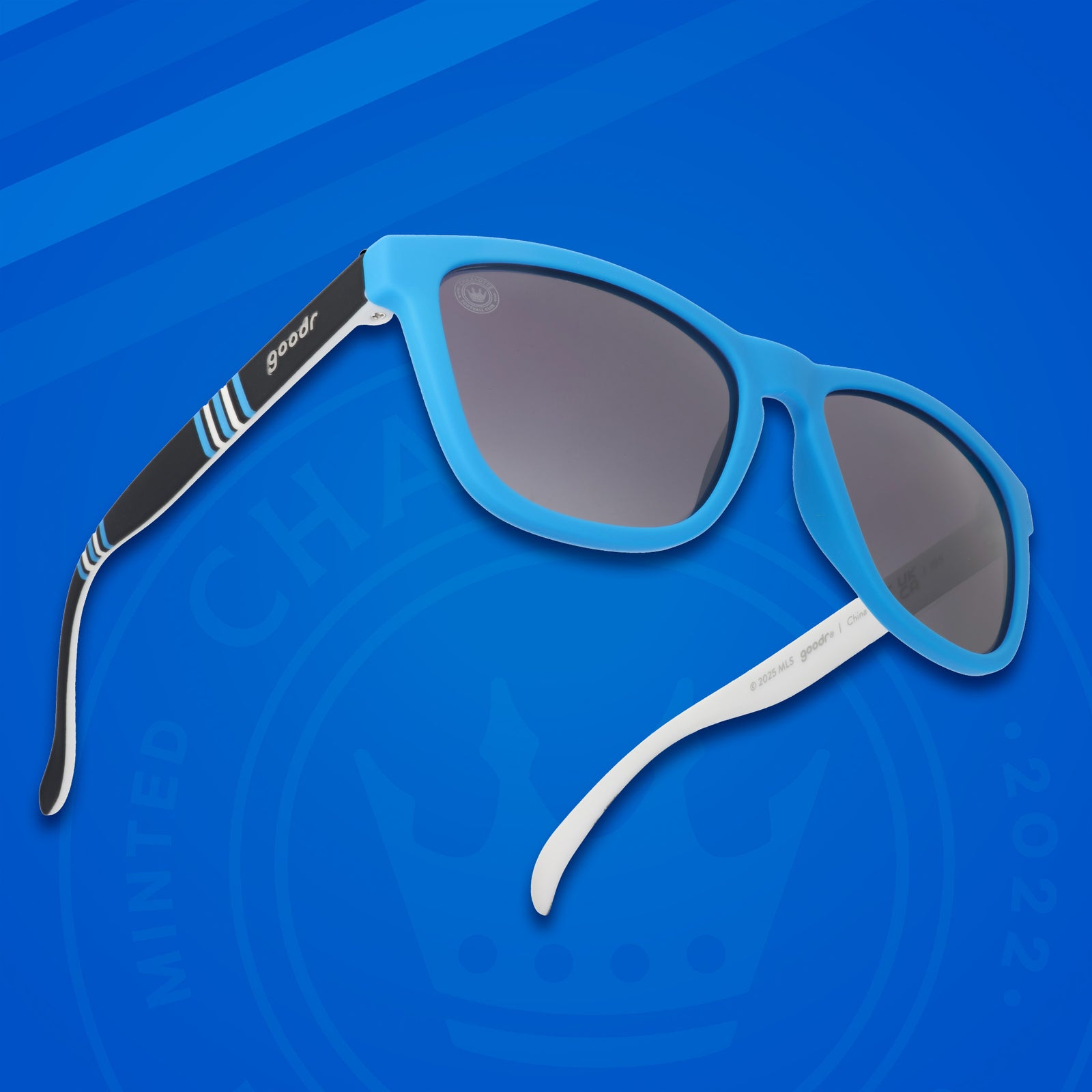 Three-quarter angle view of Major League Soccer Charlotte FC shades. Blue+black frames. Black gradient lenses.