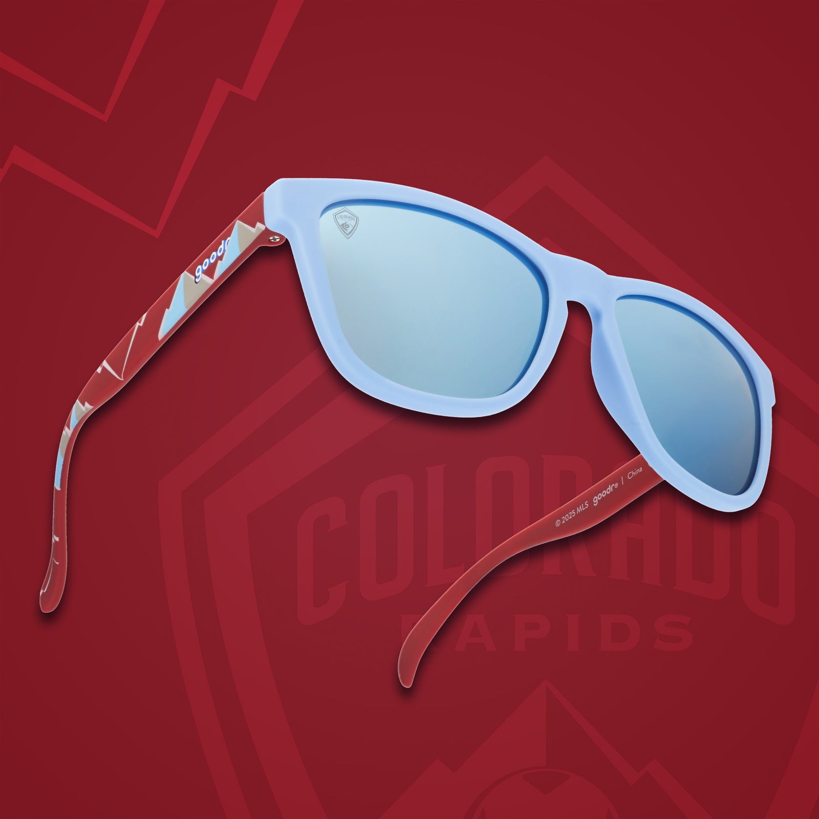 Three-quarter angle view of MLS Colorado Rapids shades. Blue+red patterned frames. Ice blue reflective lenses.