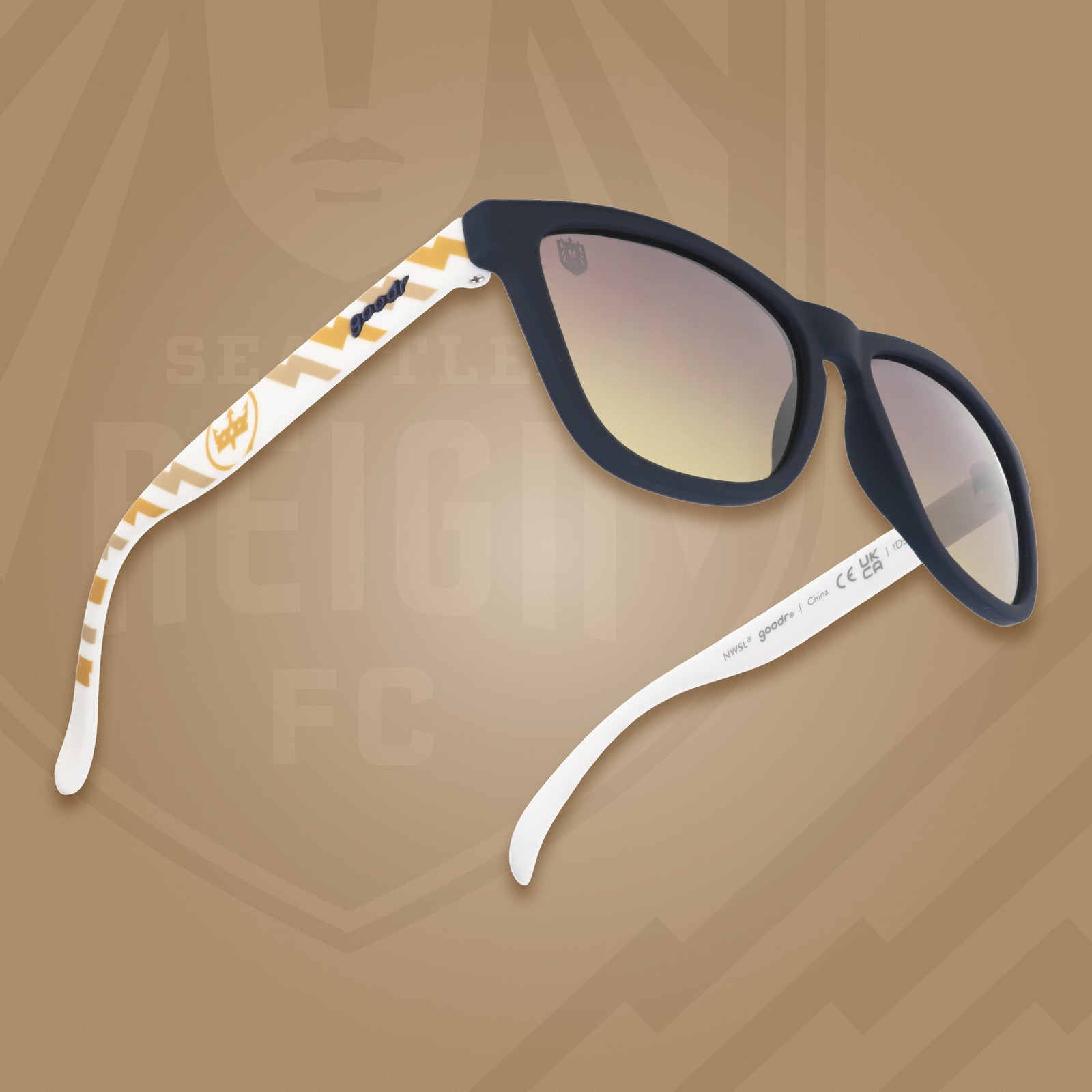 Right three-quarter angle view of black & white sunglasses with a golden sunrise pattern, Seattle Reign crown logo & gray-to-yellow gradient lenses.