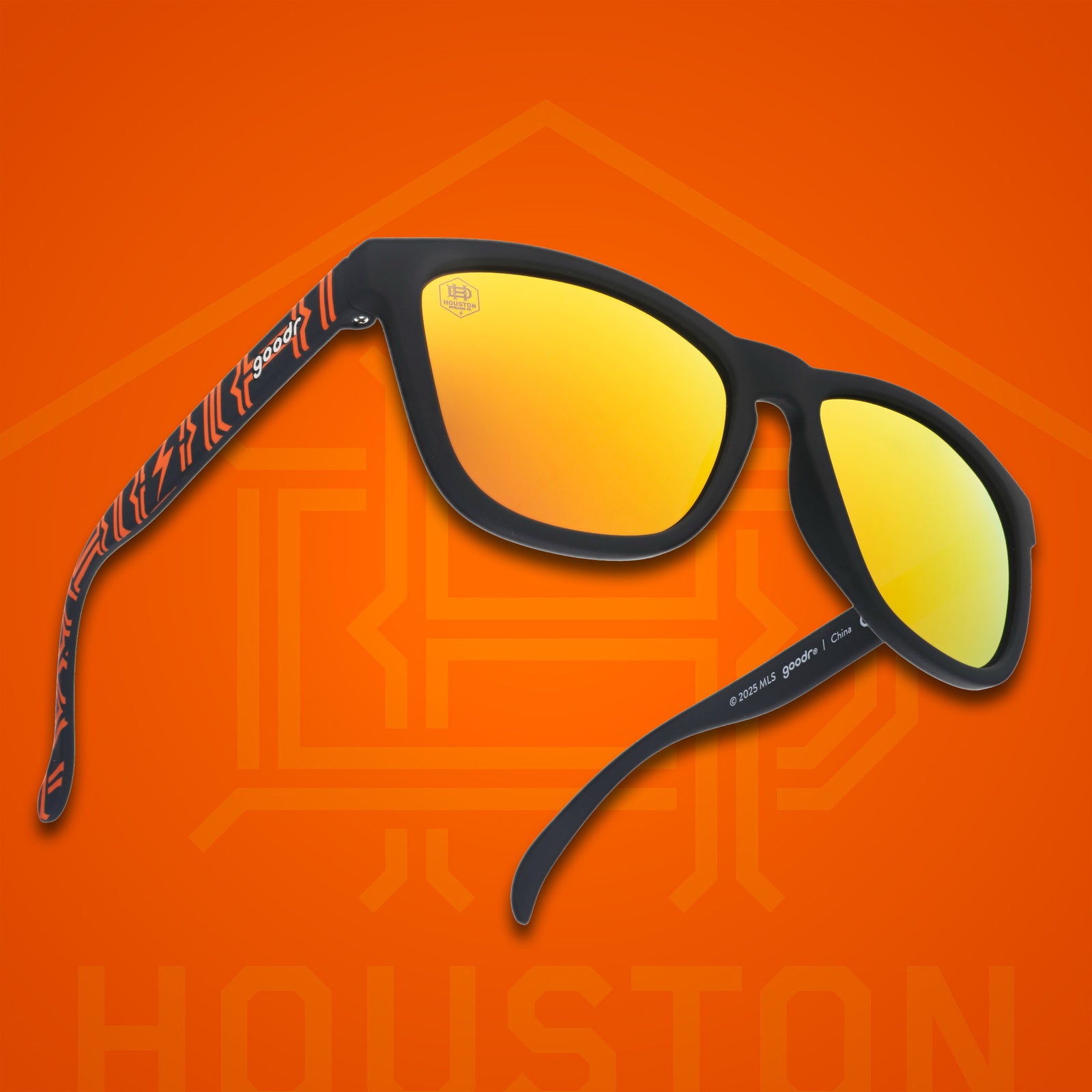 Three-quarter angle view of MLS Houston Dynamo FC shades. Black+orange frames. Amber reflective lenses.
