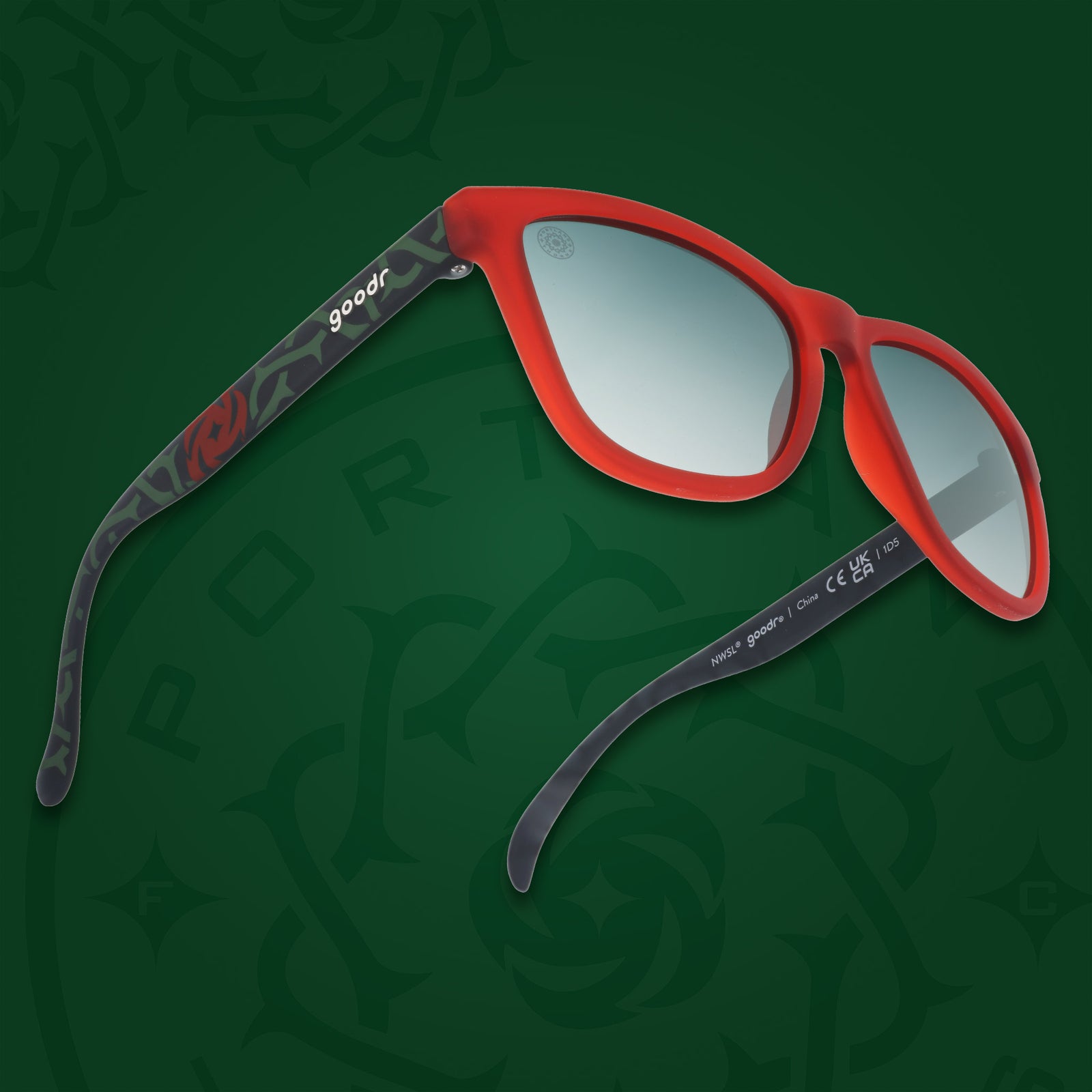 Right three-quarter angle view of red and black frames with a green thorn pattern, green gradient lenses, and the Portland Thorns logo.