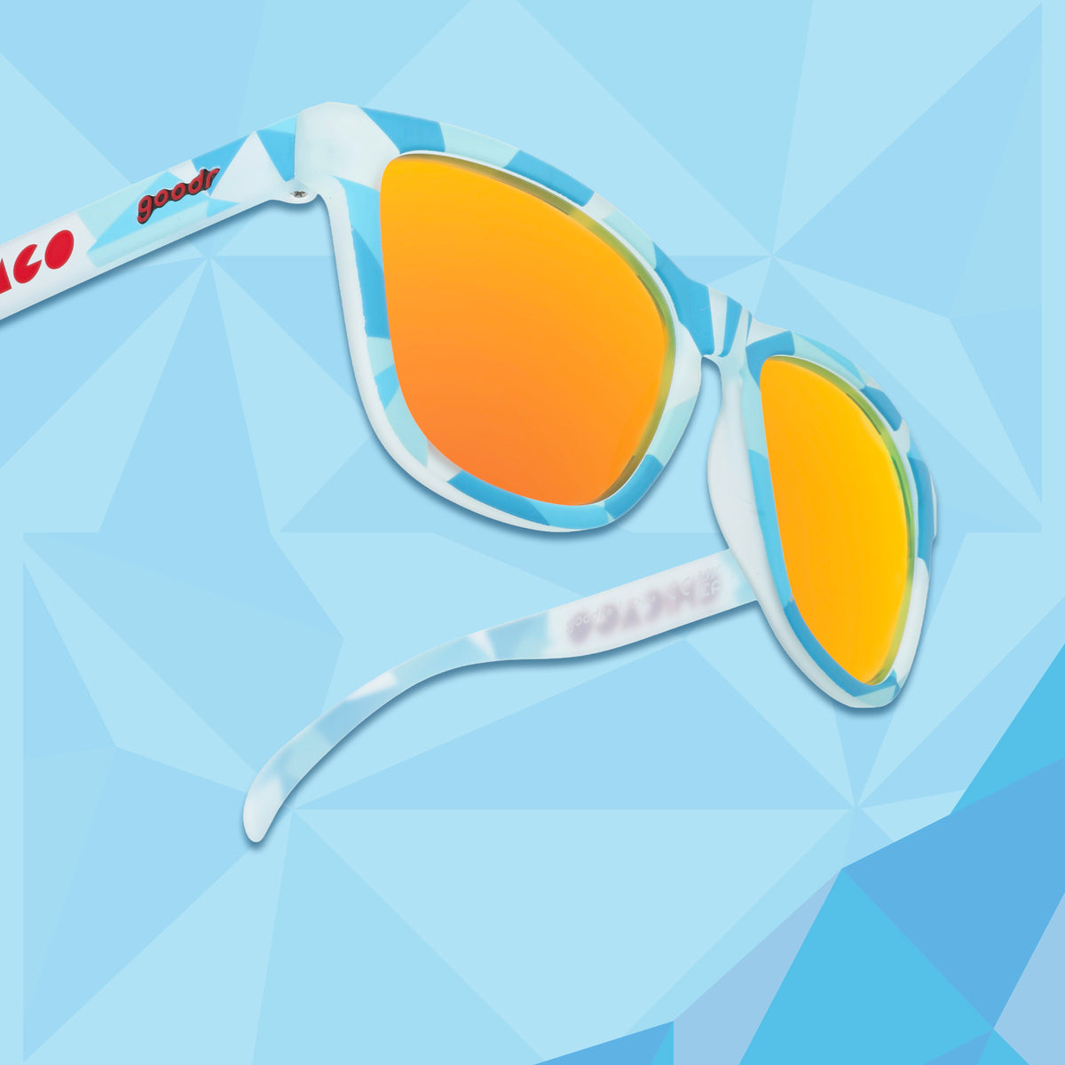 Right temple view of translucent blue, geometric-patterned sunglasses with burnt orange reflective lenses against a blue geometric background.