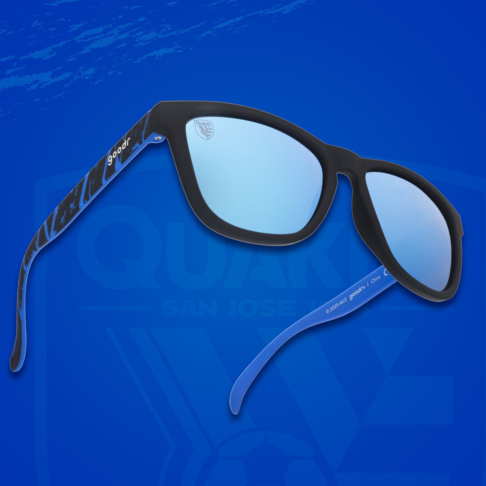 Three-quarter angle view of MLS San Jose Earthquakes shades. Black+blue frames. Blue reflective lenses.