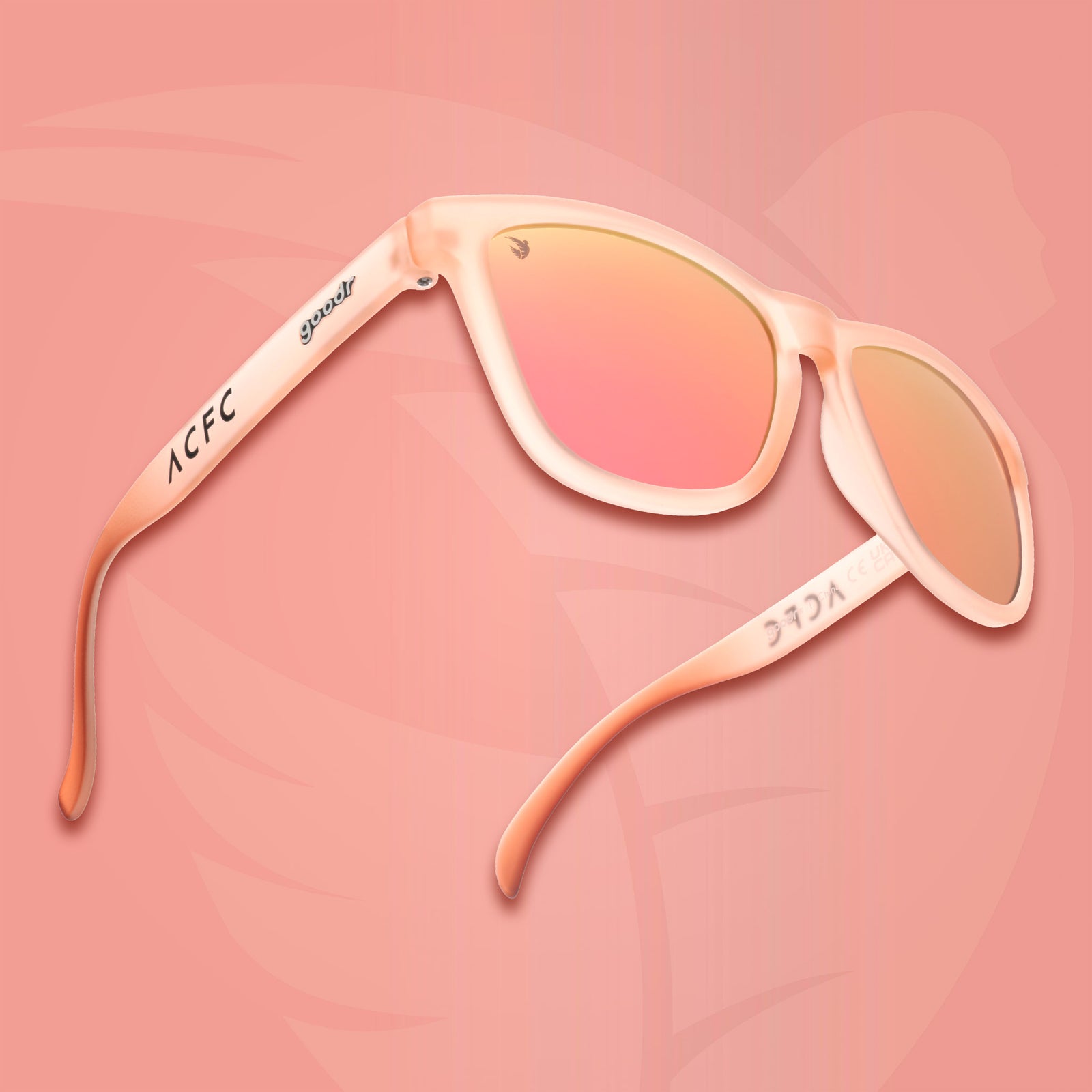 Three-quarter angle view of translucent pink sol rosa sunglasses with reflective champagne gold lenses & ACFC logo on a pick background.