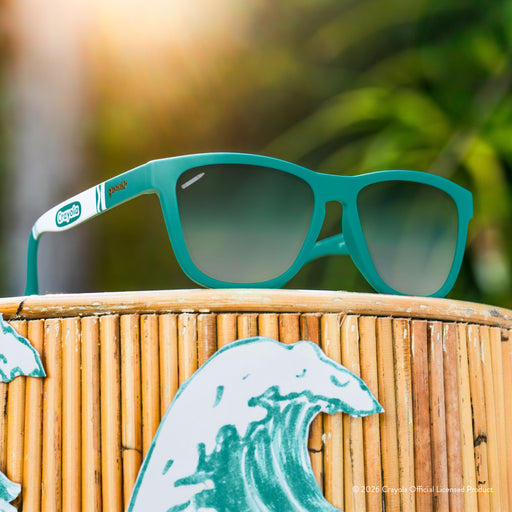 Angled view of turquoise shades w/ white Crayola marker pattern. Green gradient lenses w/ small crayon etching.
