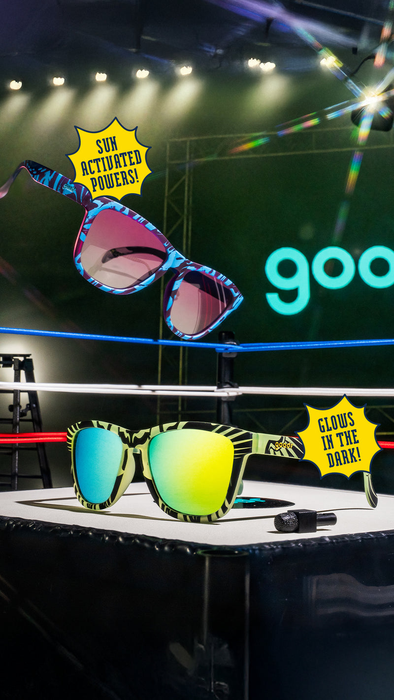 Colorful sunglasses on a stage with 'goodr' branding and light effects.