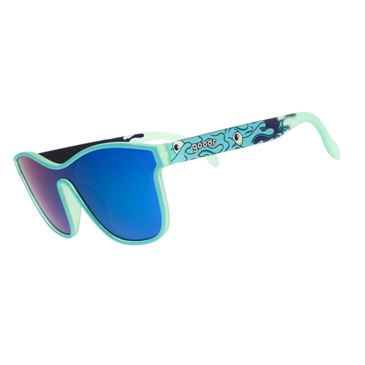 Mint green shield sunglasses with blue mirrored lenses and a wavy cartoon eye pattern on the arms.