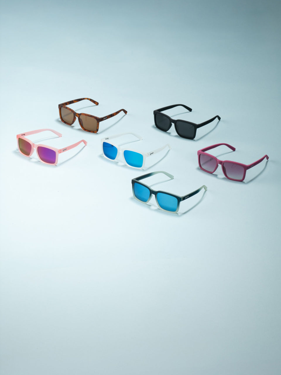Set of colorful sunglasses on a light gray background