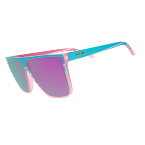 Three-quarter-angle view of translucent pink flat-top Fly G sunglasses with teal retrowave-striped design. 