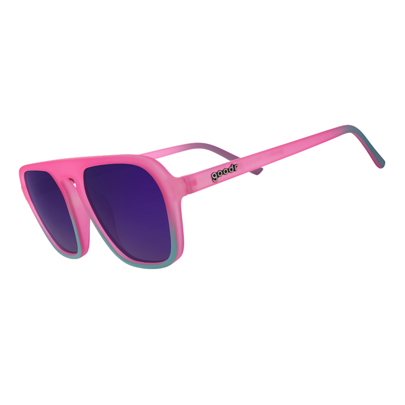 Three-quarter angle view of pink and teal aviator sunglasses with reflective lenses against a white backdrop.