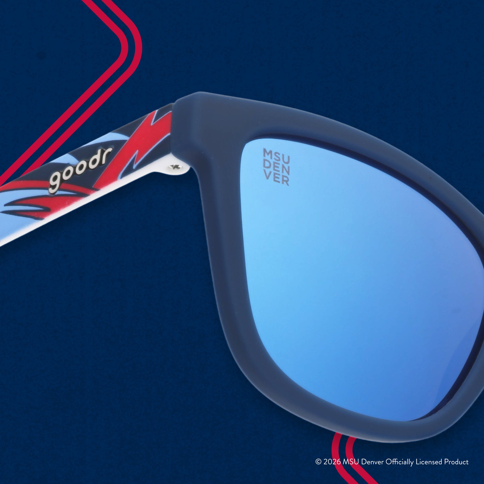 Close-up view of shades. Blue frames w/ a red+white pattern. MSU DENVER etching in top corner of blue reflective lens.