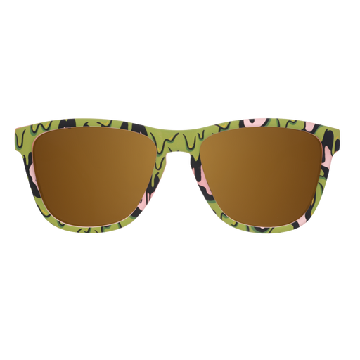 Front view of pink sunglasses with gold lenses and a gooey green-and-black slime pattern on white.