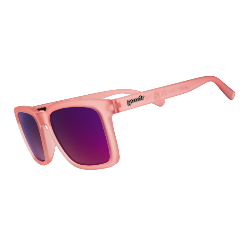 Angled view of translucent light pink shades with pink reflective lenses and a classic square silhouette tilted down.